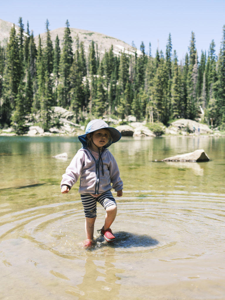 Girl wading in Brady Lake in the Holy Cross Wilderness, Colorado