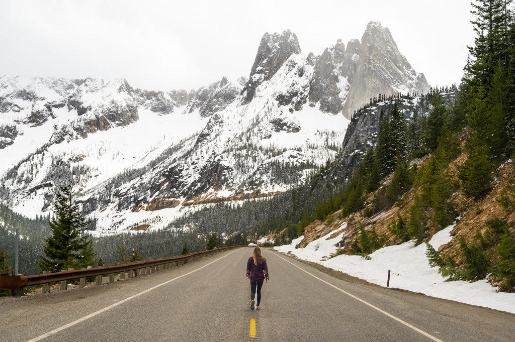 Female standing on the road in The North Cascades