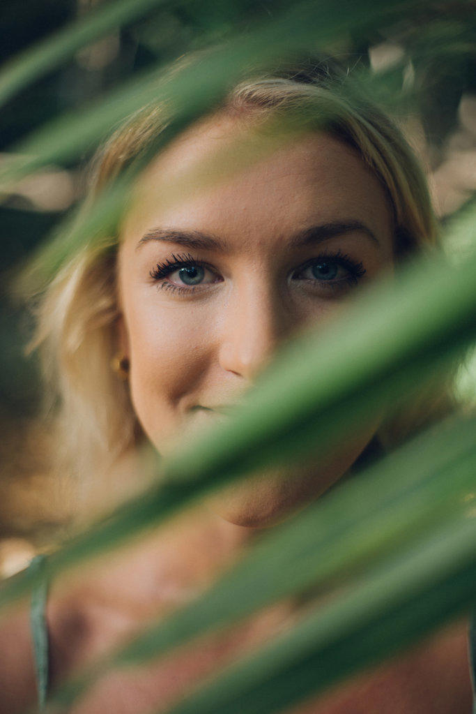 close portrait of a beauty blond girl in the jungle
