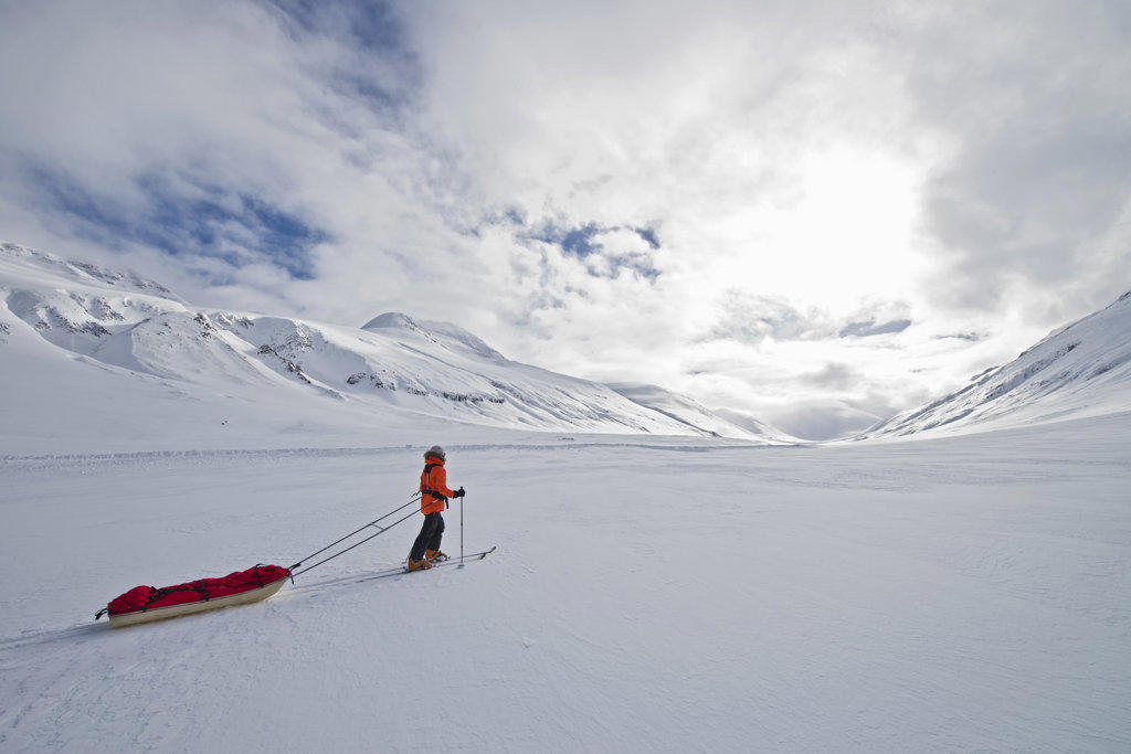 woman on touring ski's dragging sled through the Icelandic highlands