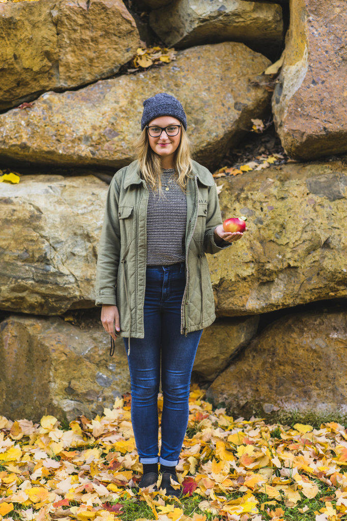 Portrait of young teenage girl holding apple