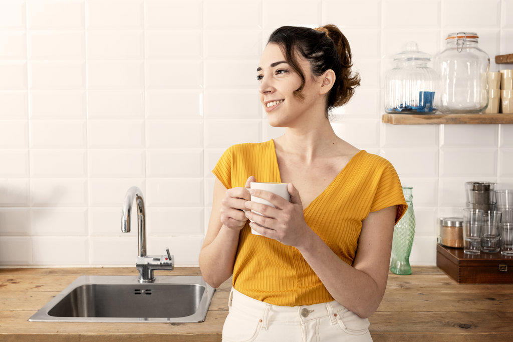 Young woman enjoying coffee at home