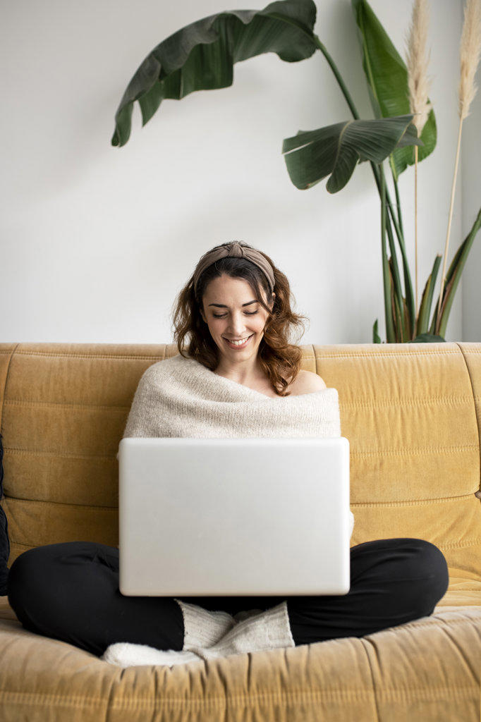 Young beautiful woman using a laptop at home