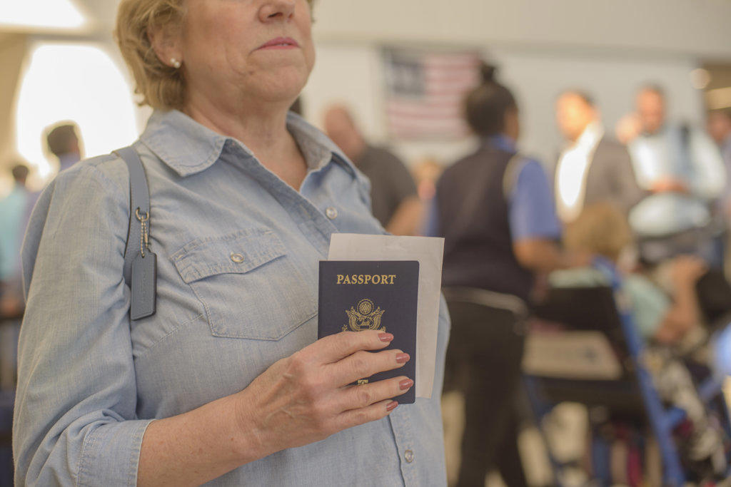 Woman with passport & boarding pass at airport