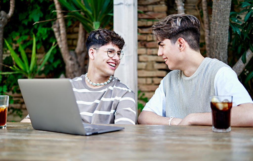 Gay Couple influencers Recording Video Of Themselves Using laptop