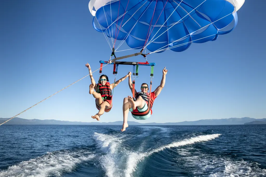 A man and a woman enjoy parasailing in South Lake Tahoe, California.