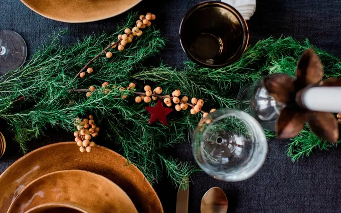 greenery and berries on a decorated festive dinner table