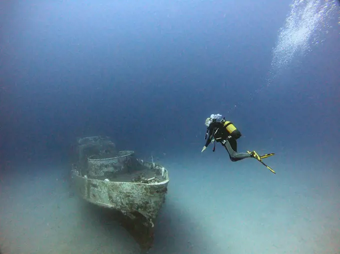 A diver dives next to the wreck.Antalya KaÅŸ Turkey