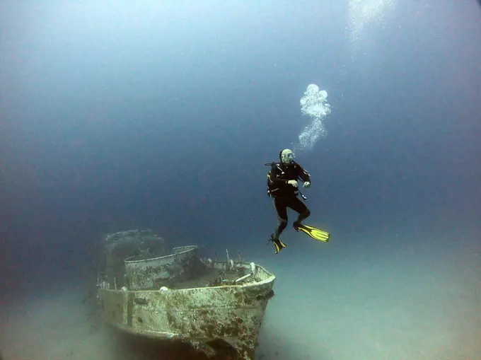 A diver dives next to the wreck.Antalya KaÅŸ Turkey