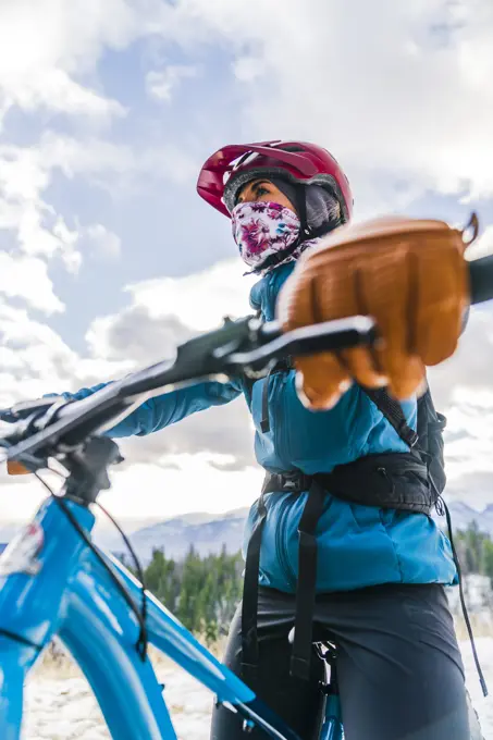Female Fat Biking With Mask During Winter In Jasper