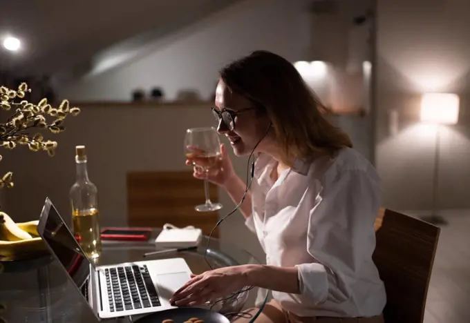 Modern businesswoman enjoying online meeting with friends