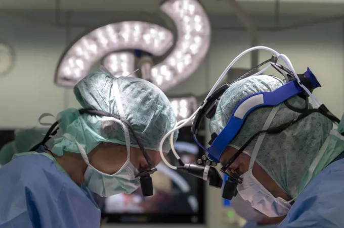 two cardiac surgeons operating on a patient