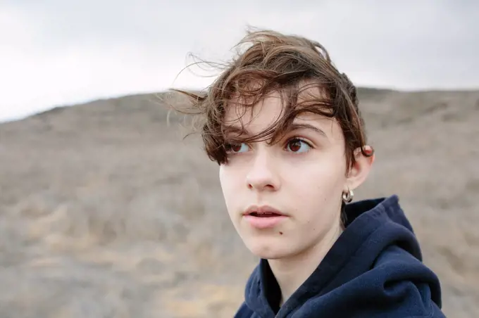 Teen Girl With Short Brown Hair Looks Pensive Outside While Hiking
