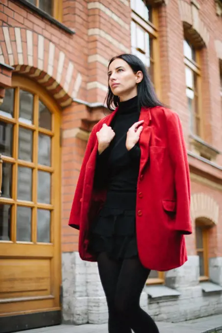 Young style fashion woman in red jacket in city