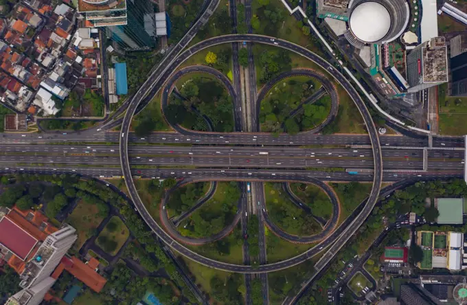 Top down overhead aerial view of large multi lane roundabout in Jakarta, Indonesia Large traffic junction on a highway with car traffic
