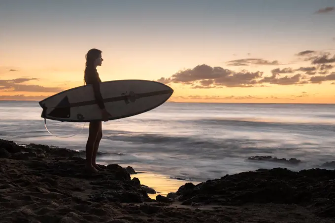 Surfer Girl Silhouette Against Colorful Sunset