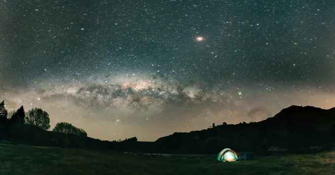Panoramic view of beauriful night landscape with tent in New Zealand