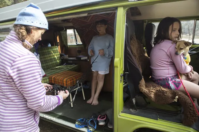 A mother,  two children and chihuahua on vacation in their VW van