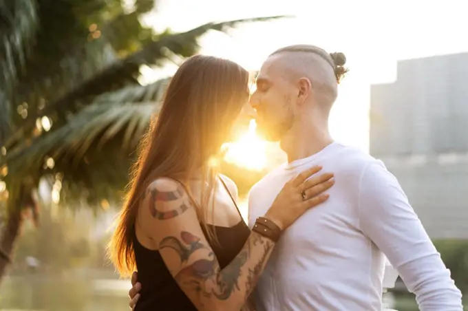 couple in love at sunset in the sunshine in tropical metropolis