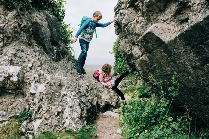 kids climbing on rocks at Corfe Castle exploring the countryside