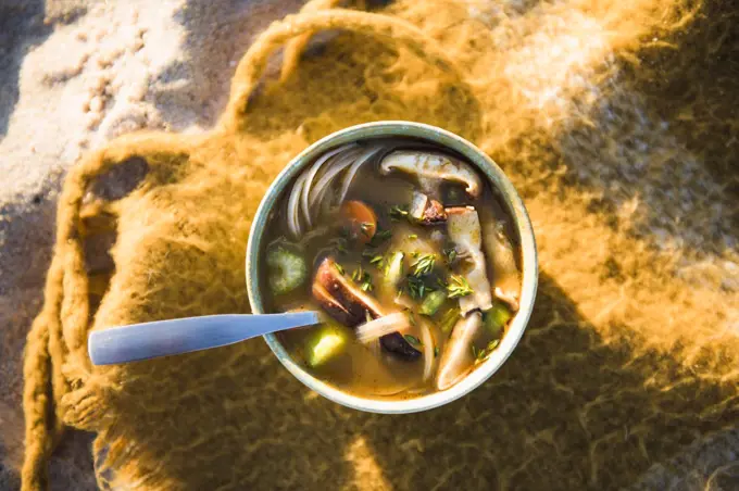 Vertical shot of soup while beach car camping