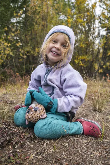 Happy girl with toy in the wilderness, Colorado