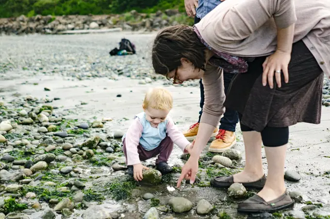 Straight on portrait of a mom and daughter tide pooling in Seattle