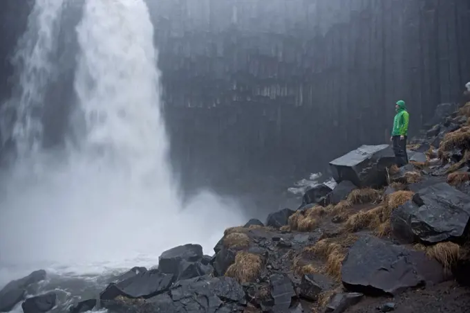 Woman looking at Svartifoss waterfall at Skaftafell