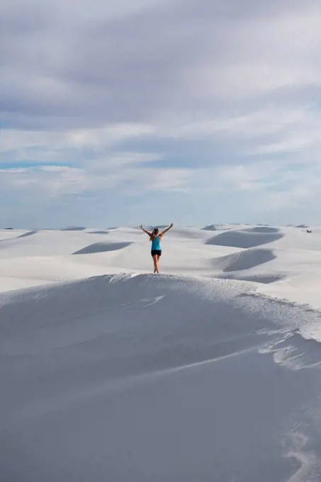 Girl exploring sand dunes in White Sands National Monument, New Mexico