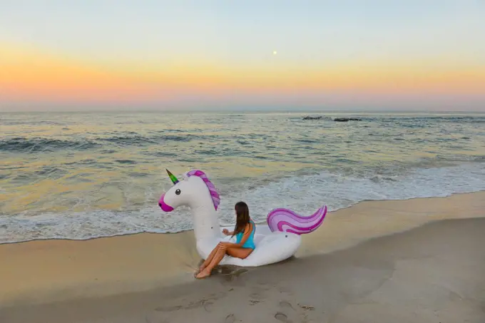 Magical Girl Sits On Unicorn Raft On Beach In Spring Lake, New Jersey