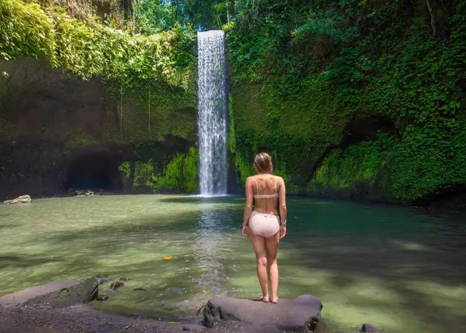 Girl At Tranquil Waterfall In Bali Indonesia