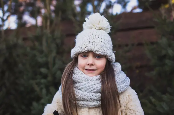 5 years girl at the outdoors market of Christmase trees