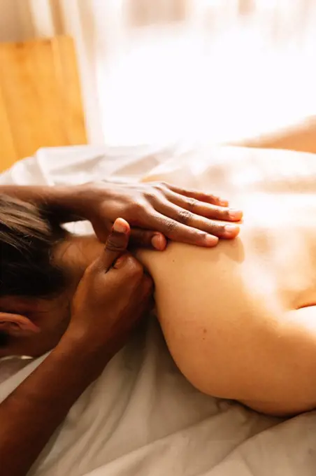 Hands of african american professional therapist giving a massage