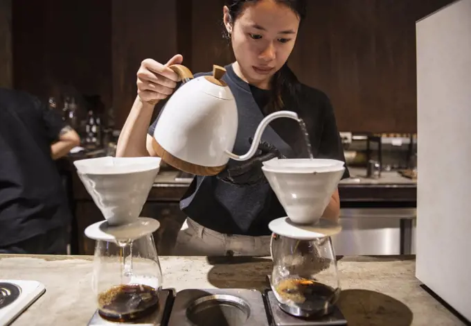 Barista preparing drip coffee at slow coffee bar in Bangkok