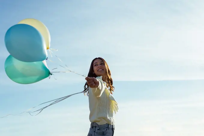 Beautiful Young Woman Having Fun With Colorful Balloons