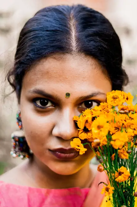 Portrait of a woman posing with flower