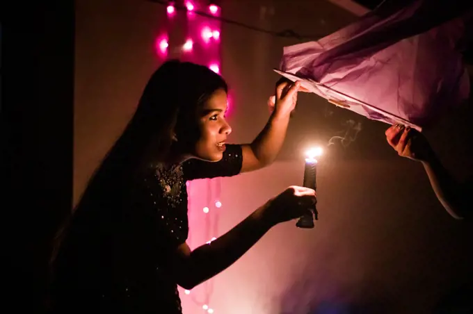 Photo of a girl holding candle in India