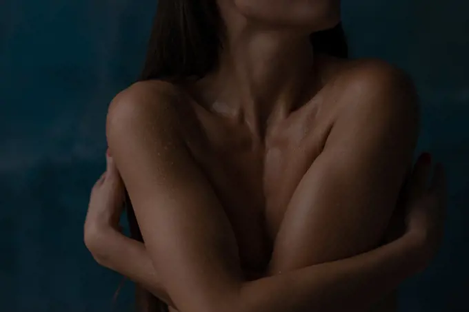 Beautiful burn woman embracing herself with naked body