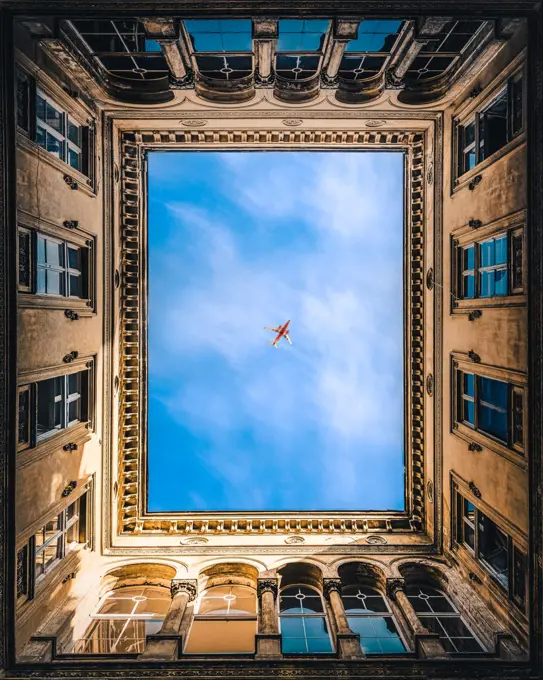 Airplane framed by buildings in Budapest, Hungary