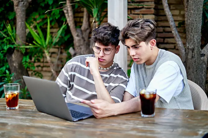 Couple influencers Recording Video Of Themselves Using laptop
