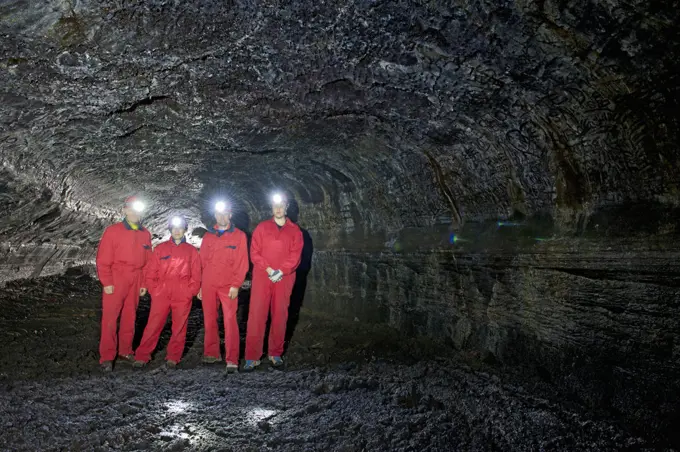 group of scientists exploring the Leidarendi lava cave in Iceland