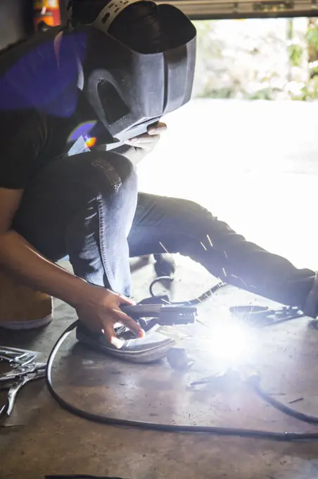 mechanic welding at custom bike shop in Bangkok