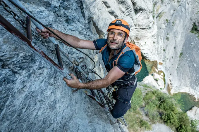 56-year-old male climber going up a via ferrata