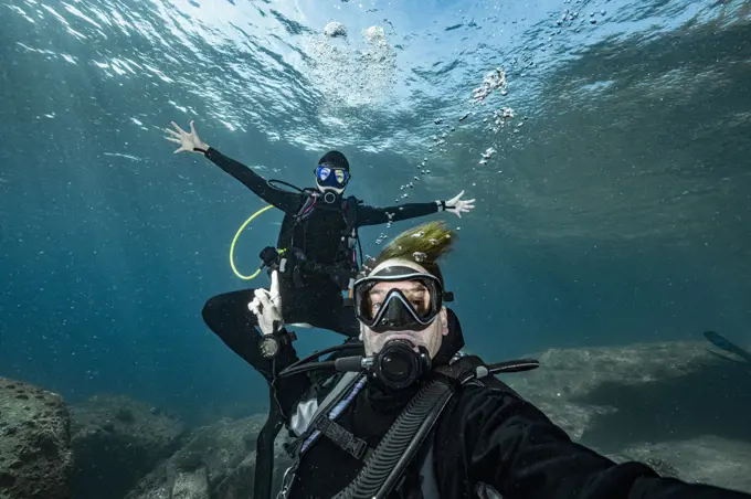 couple taking selfie under water at the Andaman Sea in Thailand