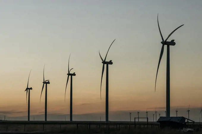Industrial wind farm windmills at sunset, Adrian, Texas