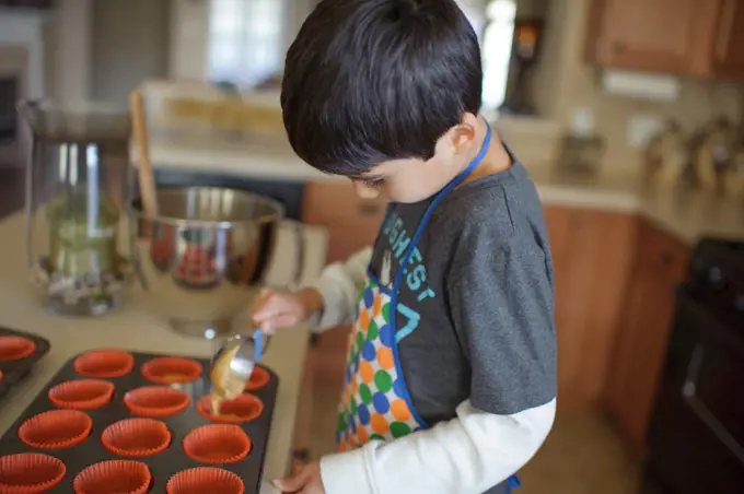 A Little Boy Baking Cupcakes