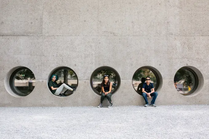 Siblings Sit In Circle Shaped Windows In Zurich