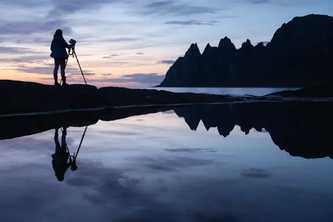 Photographer and Okshornan at Tungeneset viewpoint, Senja, Norway