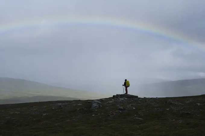 Hiker under rainbow, Padjelantaleden - Padjelanta trail, Sweden
