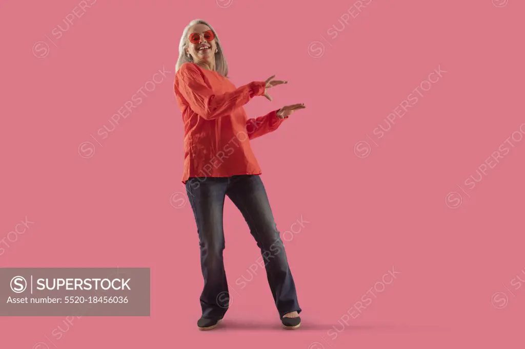 An old lady dancing being modishly dressed. 